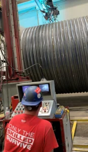 Skilled craftsman overseeing the fabrication of a half-pipe reactor in Cincinnati fabrication shop.